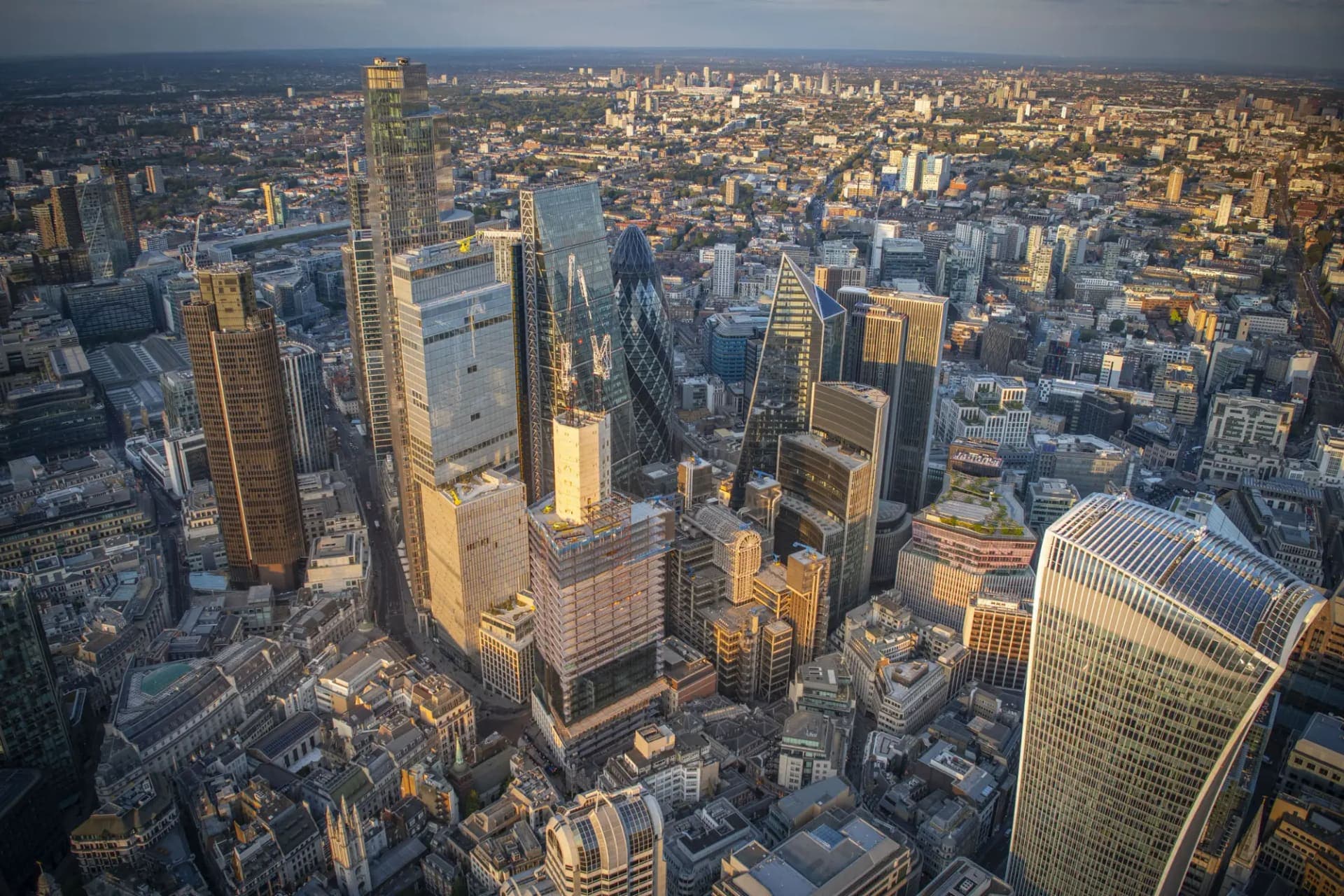 The City of London skyline from the air at golden hour